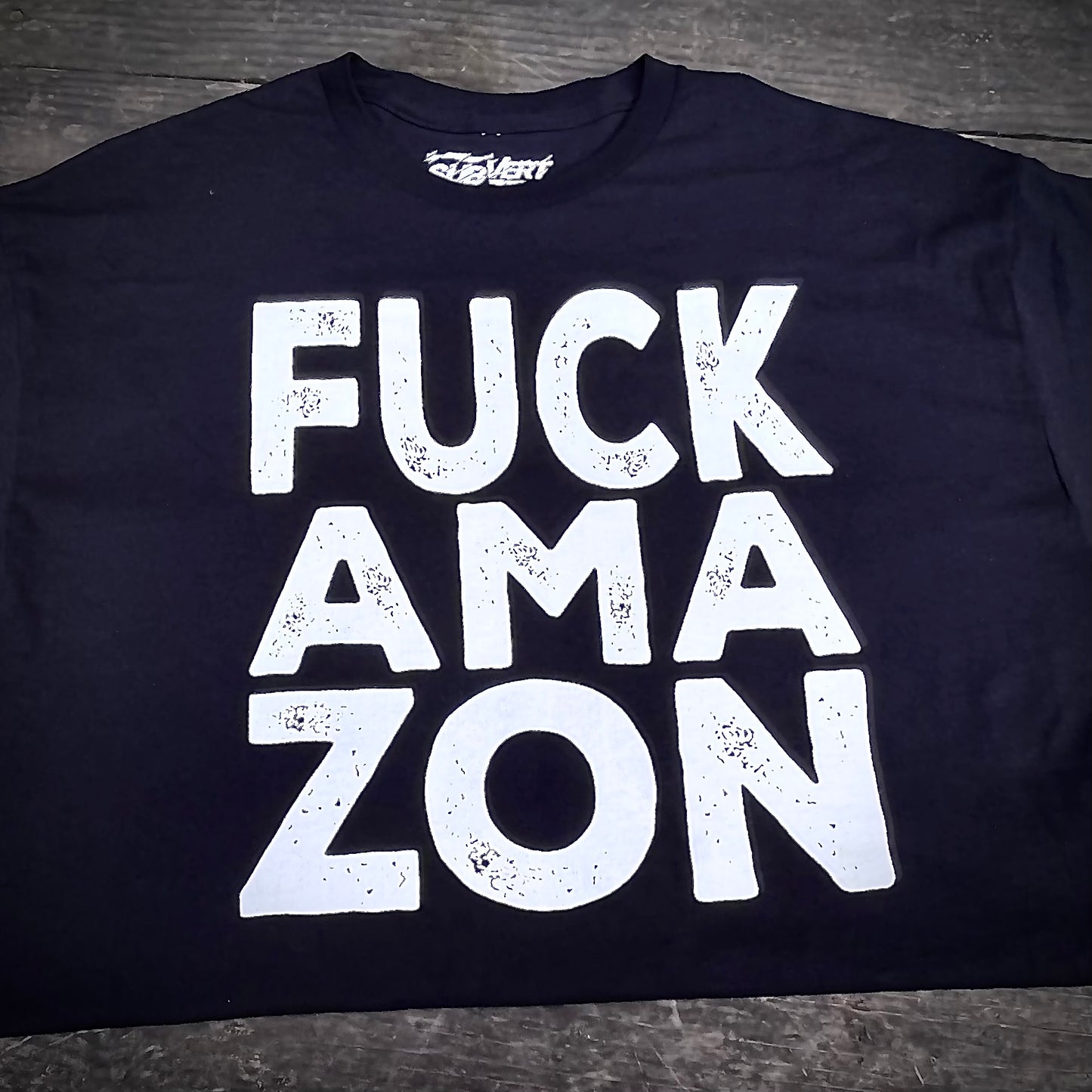 Black t-shirt that reads Fuck Ama-Zon in bold white lettering.